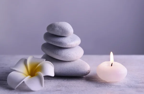 White spa stones with candle — Stock Photo, Image