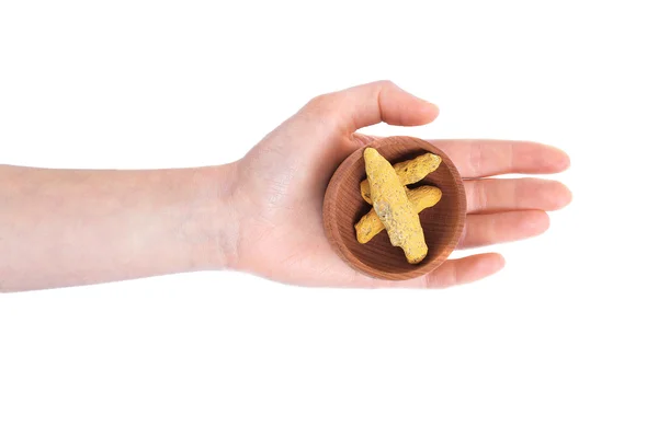 Hand holding bowl with turmeric root — Stock Photo, Image