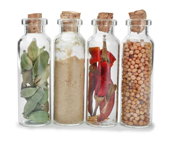 Assorted dry spices in glass bottles — Stock Photo, Image