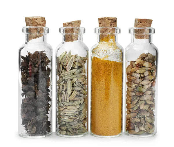 Surtido de especias secas en botellas de vidrio —  Fotos de Stock