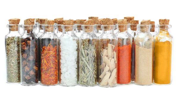 Assorted dry spices in glass bottles — Stock Photo, Image