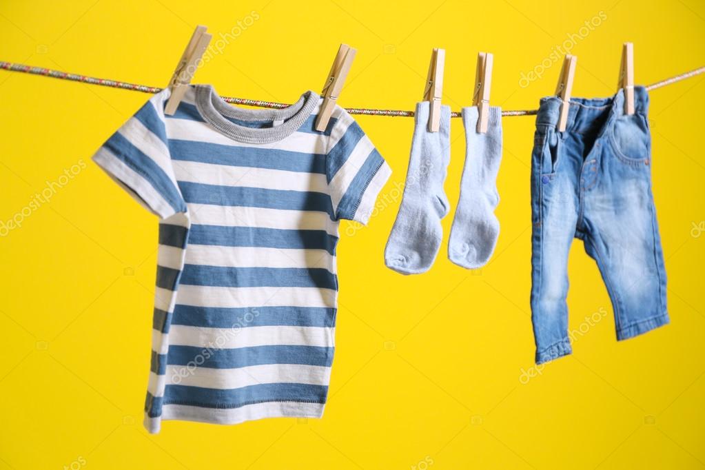 Baby clothes hanging on rope — Stock Photo © belchonock #114906414