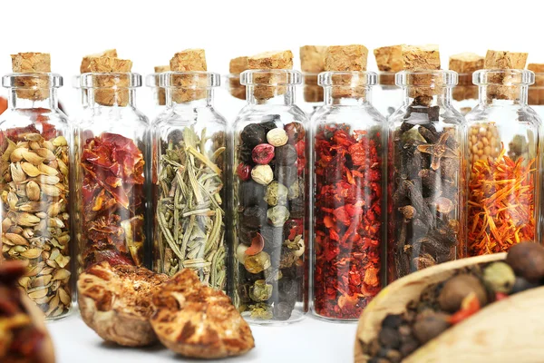 Assorted dry spices in glass bottles — Stock Photo, Image