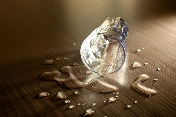 Glass and drops on table — Stock Photo, Image