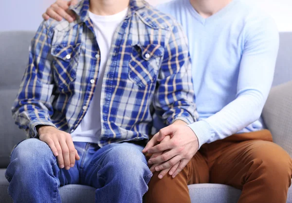 Homosexuals sitting on sofa — Stock Photo, Image