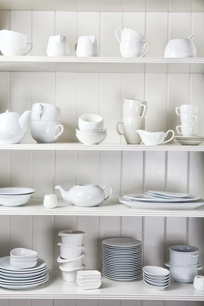 Dishes in cupboard in the kitchen — Stock Photo, Image