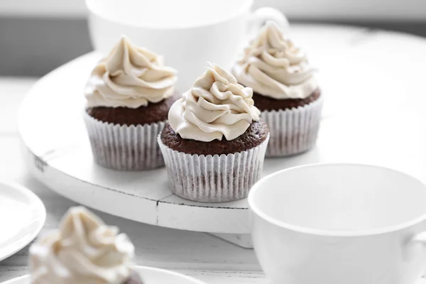 Tasty cupcakes on wooden table — Stock Photo, Image