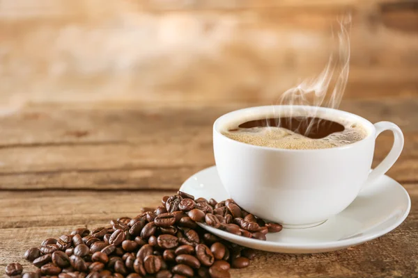 Cup of coffee with beans — Stock Photo, Image