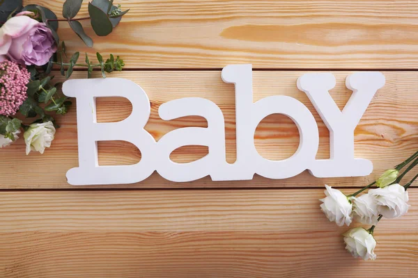 Palabra bebé con rosas — Foto de Stock