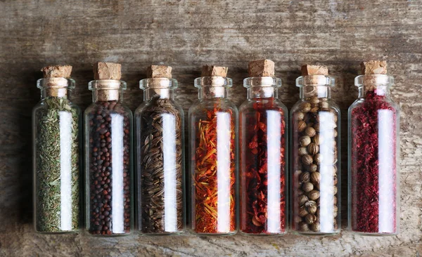 Different spices in small glass bottles — Stock Photo, Image