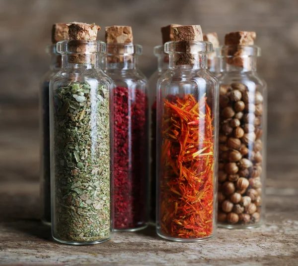 Different spices in small glass bottles — Stock Photo, Image