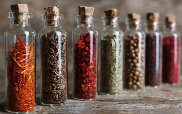 Different spices in small glass bottles — Stock Photo, Image