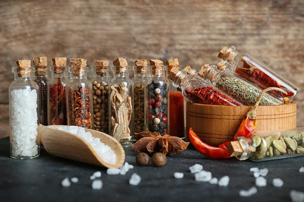 Assorted dry spices in glass bottles — Stock Photo, Image