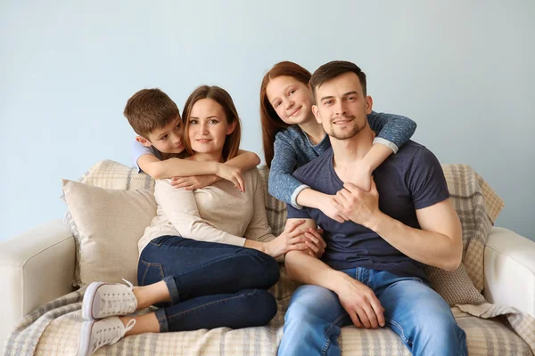 Happy Family Embracing Sofa — Stock Photo, Image