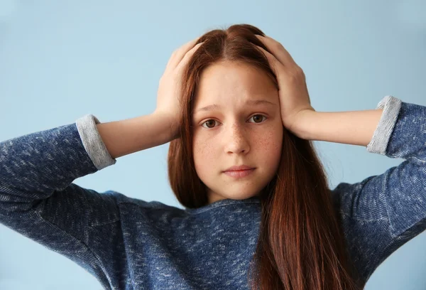 Scared girl with hands on head