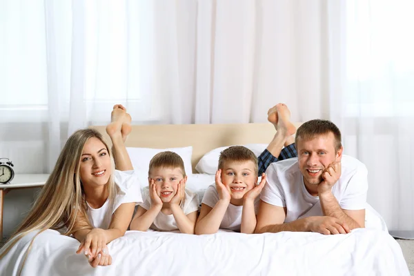 Happy lovely family on bed — Stok Foto