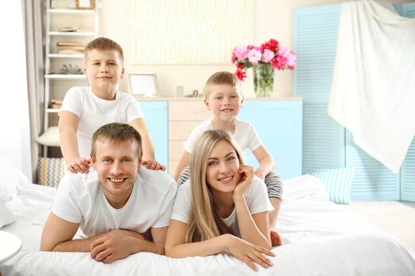 Happy lovely family on bed — Stock Photo, Image