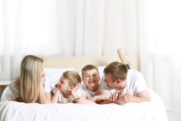 Happy lovely family on bed — Stock Photo, Image