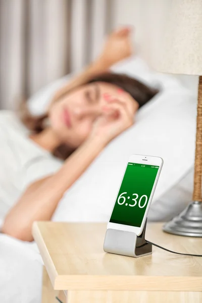 Žena probuzení s mobilní budík — Stock fotografie