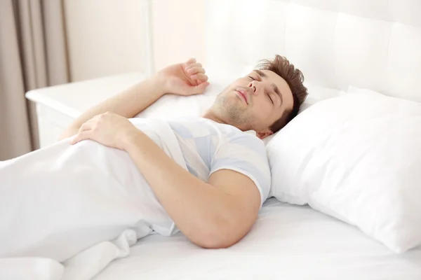Young man sleeping on bed — Stock Photo, Image