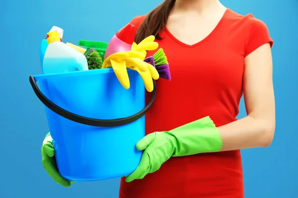 Female cleaner on blue — Stock Photo, Image