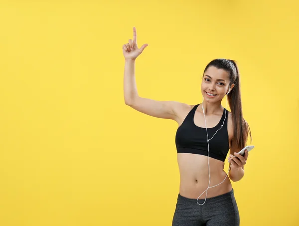 Fitness kadın işaret parmağı yukarıya — Stok fotoğraf