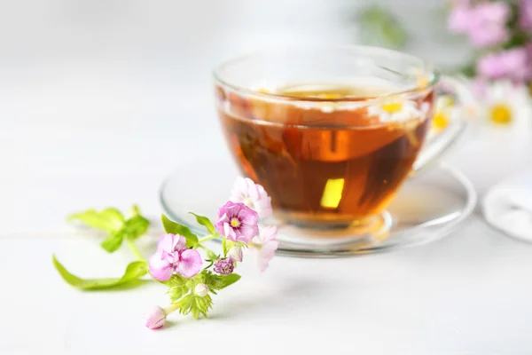 Meadow flowers and cup — Stock Photo, Image