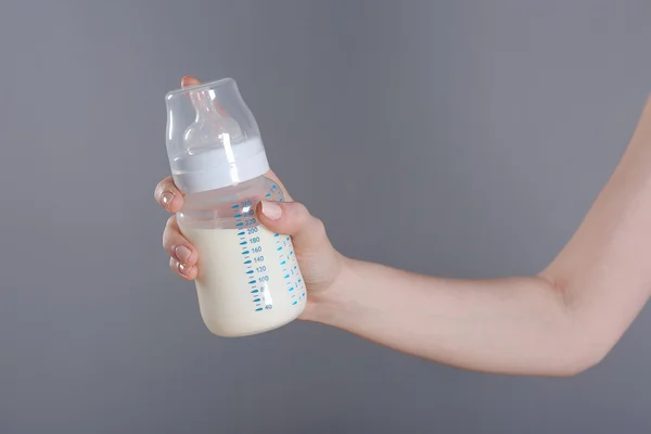 Hand hält Babyflasche mit Milch — Stockfoto