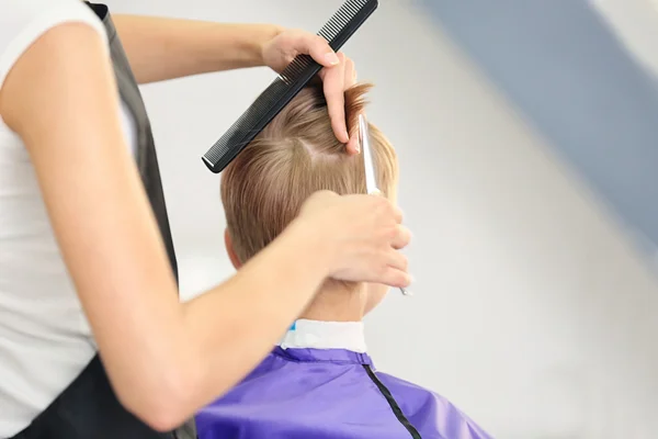 Friseur macht Frisur für Kind — Stockfoto