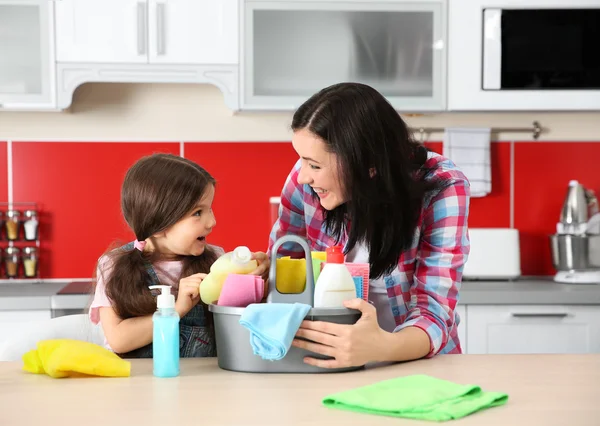 Daughter and mother in kitchen Stock Image