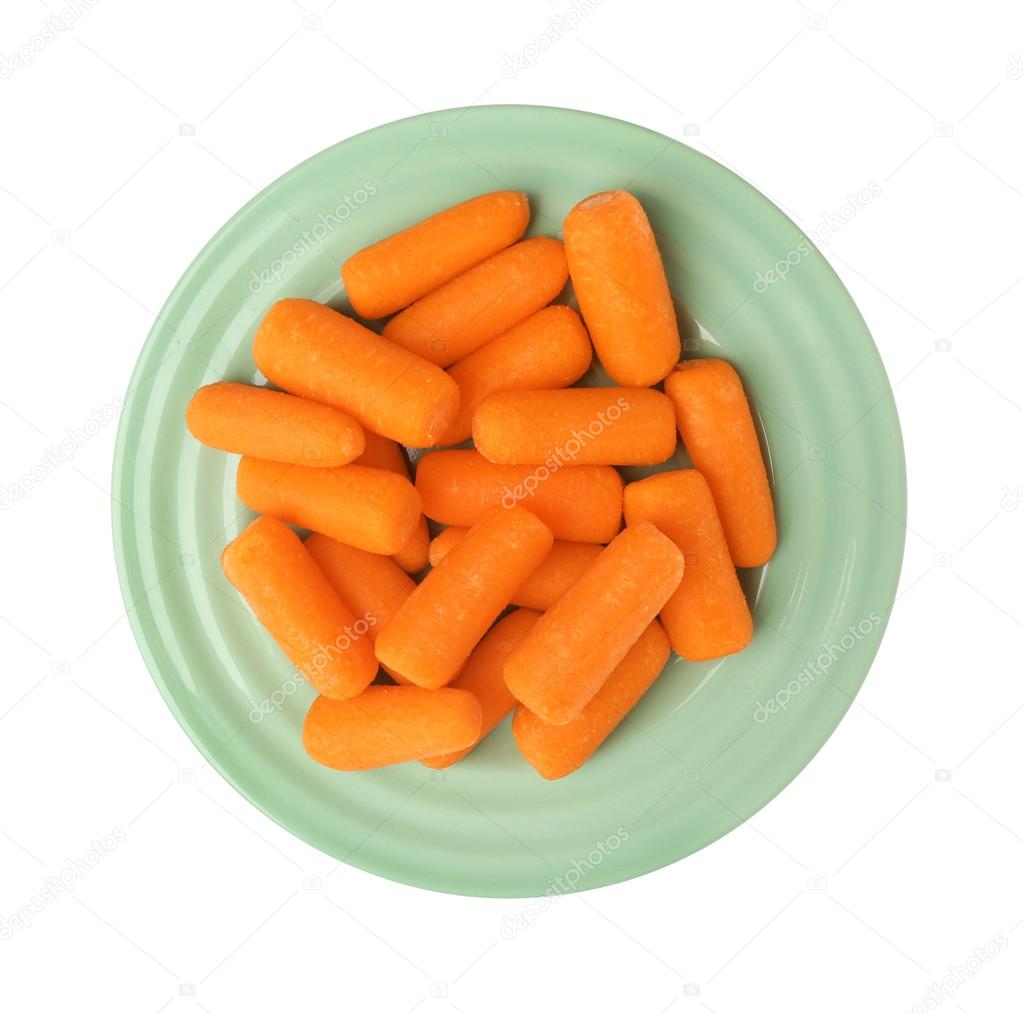Baby carrots in plate Stock Photo by ©belchonock 115674666