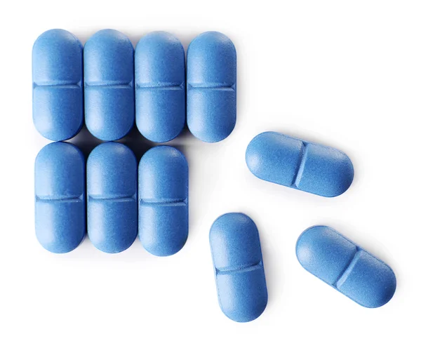 Синие таблетки на белом — стоковое фото