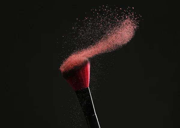 Makeup brush with flying powder — Stock Photo, Image