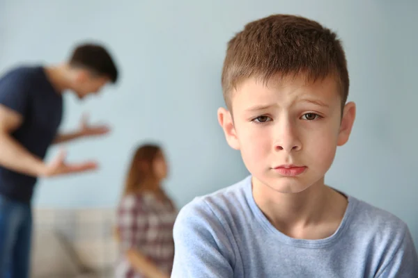 Family problems concept. Sad boy and abusing parents — Stock Photo, Image