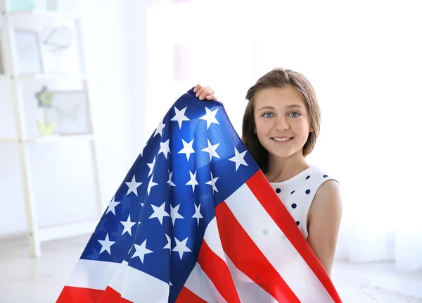 Teenage girl and American flag in room — Stock Photo, Image