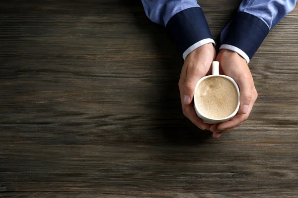 Man holding in hands cup of coffee