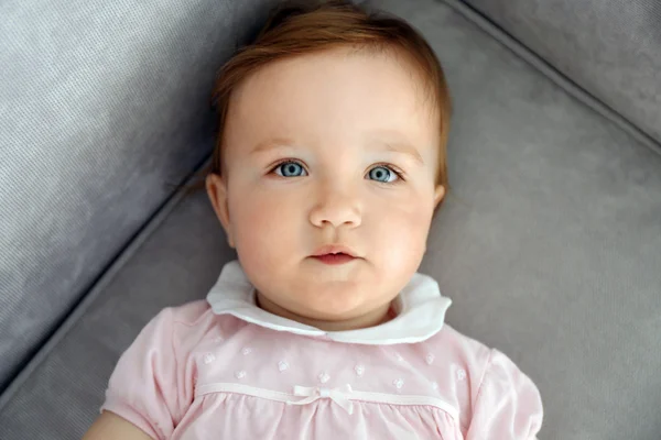 Beautiful Baby laying on sofa, closeup — стоковое фото