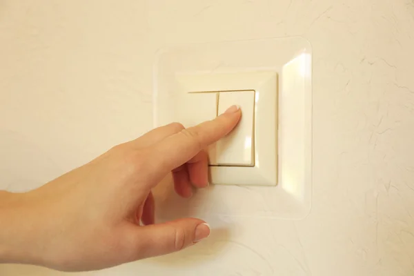 Turning on light switch — Stock Photo, Image