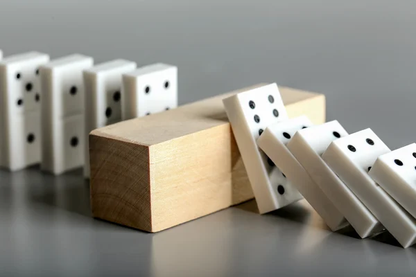 Dominoes and brick block — Stock Photo, Image