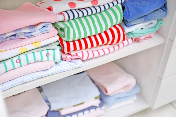 Clothes for kids on shelves — Stock Photo, Image