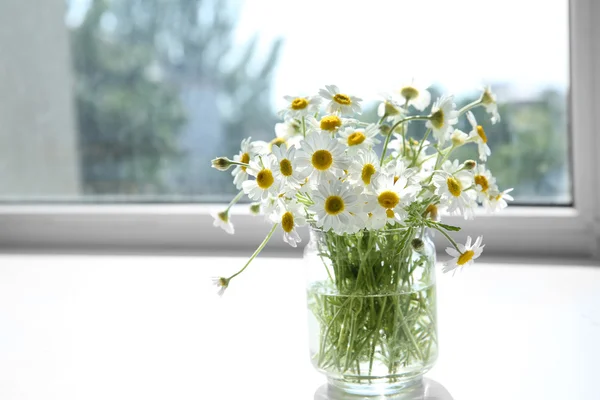 Chamomile bouquet on windowsill — Stock Photo, Image