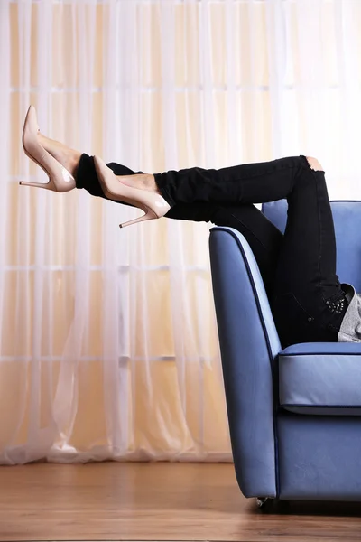 Woman legs on sofa — Stock Photo, Image