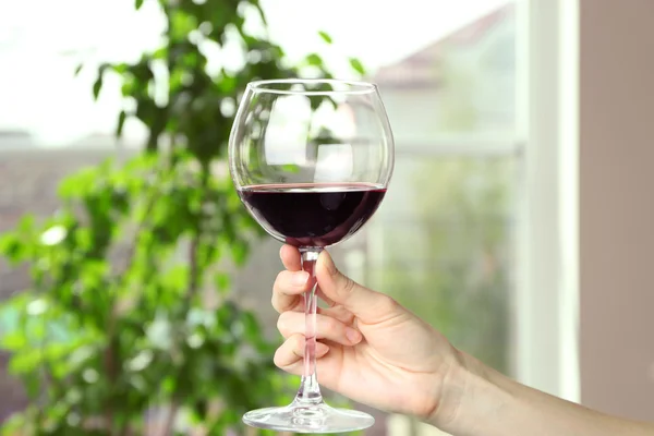 Woman holding glass of wine — Stock Photo, Image