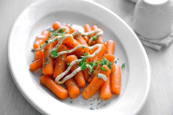 Baby carrot with greens and mayonnaise — Stock Photo, Image