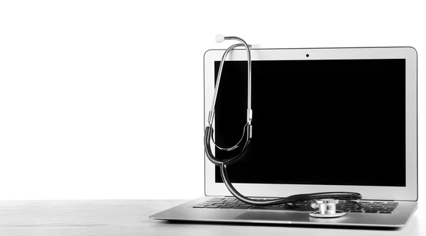 Stethoscope on modern laptop — Stock Photo, Image