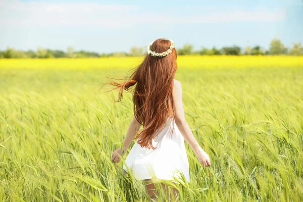 Sweet girl in meadow with wild spring flowers — Stock Photo, Image