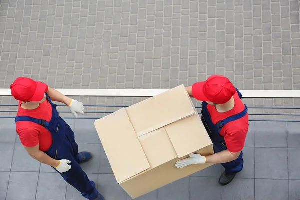 Deux travailleurs masculins avec des boîtes lourdes — Photo