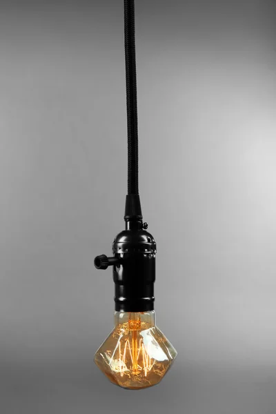 Light bulb on grey — Stock Photo, Image