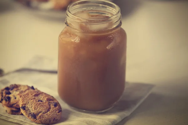 Iced coffee in glass jar — Stock Photo, Image