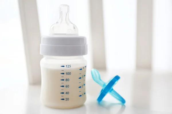 Baby milk bottle and pacifier — Stock Photo, Image